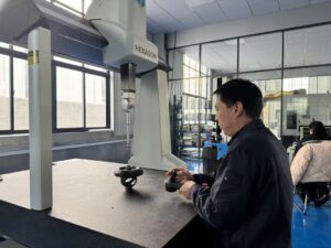 A technician using a vernier caliper to verify the dimensions of a precision-machined gear in a quality testing lab.